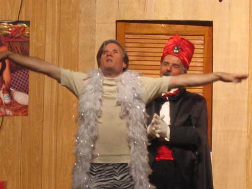 A man with outstretched arms and a man in a red turban