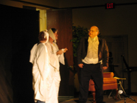 Ebenezer Scrooge addressing two ghosts