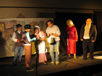 Scrooge, the Spirit, an elderly woman and some street urchins