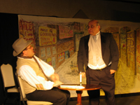 Scrooge standing and Bob Cratchit sitting