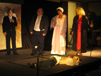 Scrooge, the Spirit, Mrs. Cratchit and Clarence standing over an urchin dressed in dog ears
